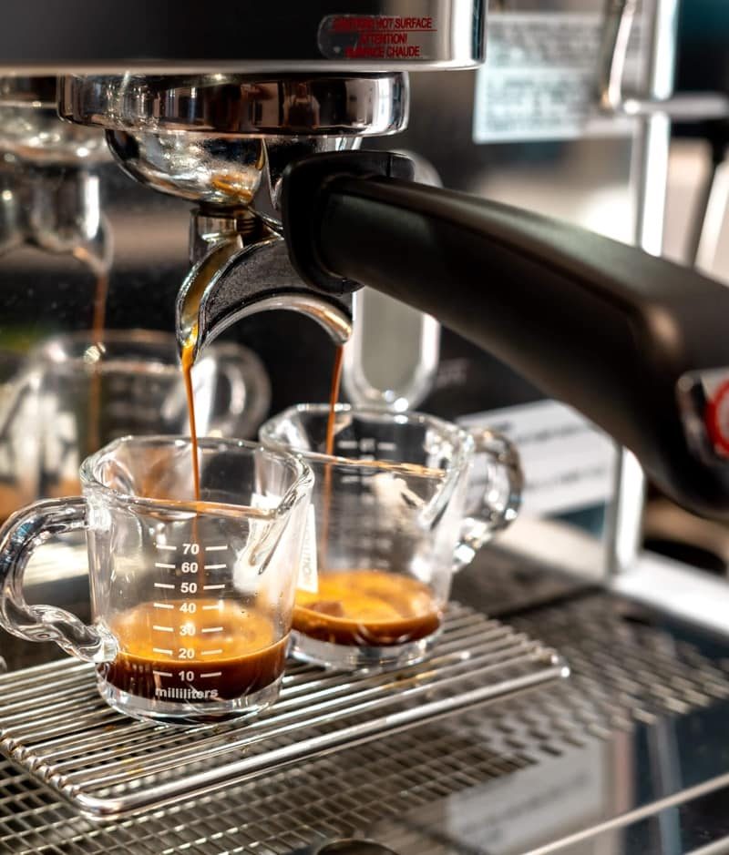 Two espresso shots pouring from the machine